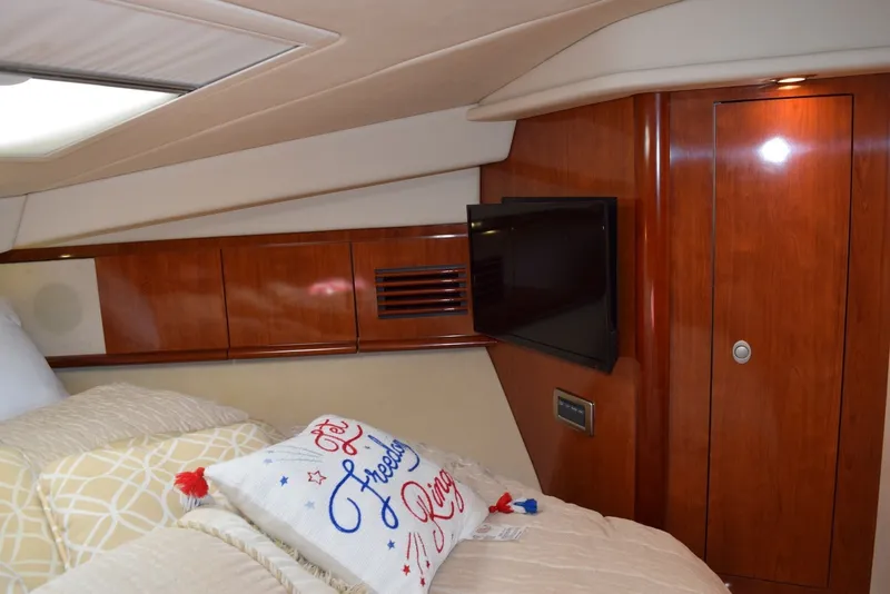 Slide: The Image of Luxurious cabin interior of 2004 Sea Ray 390 Sundancer yacht with TV and decorative pillow. - 31