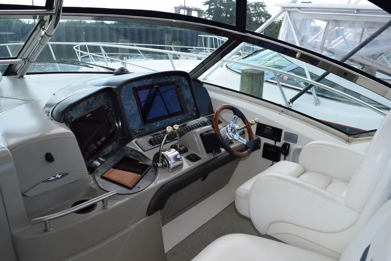 Slide: The Image of 2004 Sea Ray 390 Sundancer helm with modern controls and luxurious seating. - 18