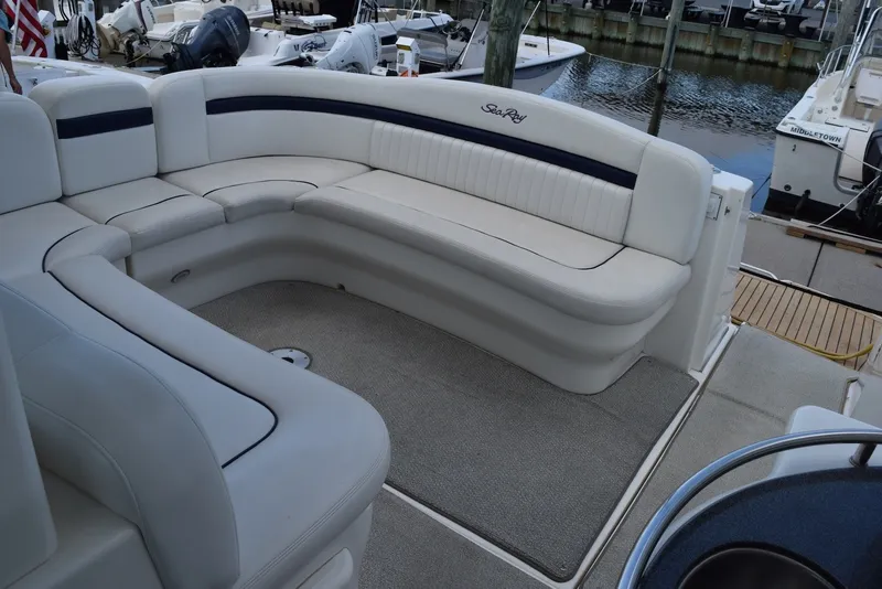 Slide: The Image of 2004 Sea Ray 390 Sundancer boat interior with white seating and carpeted floor. - 13
