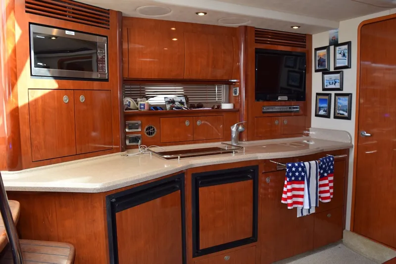 Slide: The Image of Luxurious 2004 Sea Ray 390 Sundancer yacht interior with modern kitchen amenities. - 23