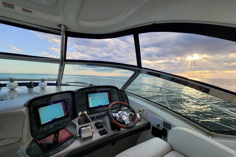 Slide: The Image of Helm of 2004 Sea Ray 390 Sundancer yacht with ocean view at sunset. - 17
