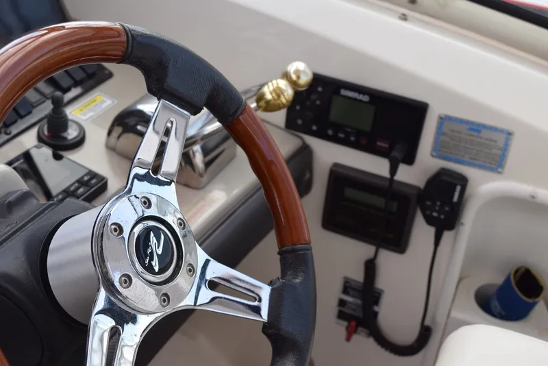 Slide: The Image of Steering wheel and controls of 2004 Sea Ray 390 Sundancer boat cockpit. - 20
