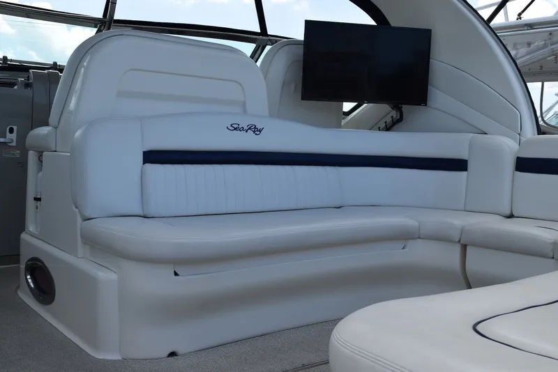 Slide: The Image of 2004 Sea Ray 390 Sundancer interior with white seating and mounted TV. - 4