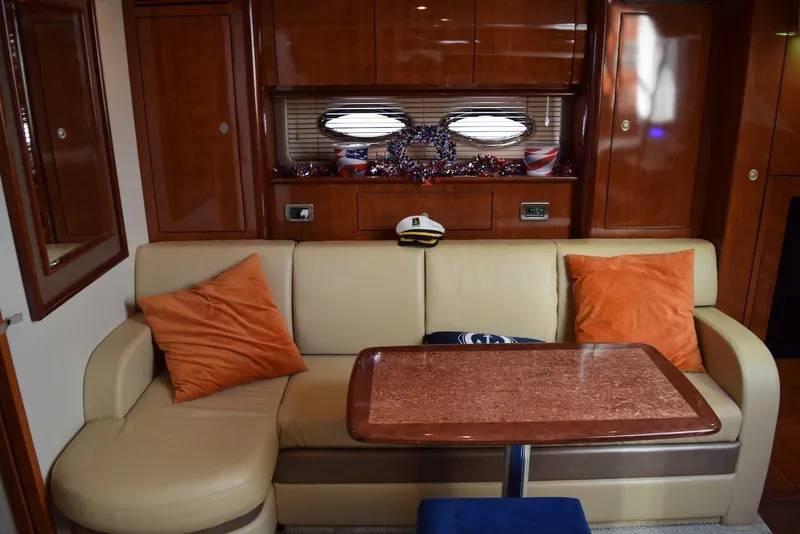 Slide: The Image of Interior of 2004 Sea Ray 390 Sundancer with beige sofa and wooden table. - 27