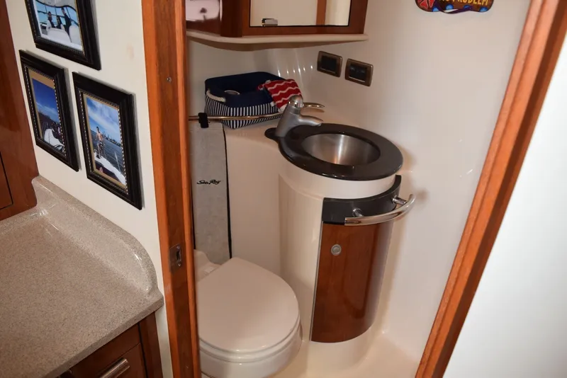 Slide: The Image of Luxurious 2004 Sea Ray 390 Sundancer bathroom with modern fixtures and elegant wood accents. - 28