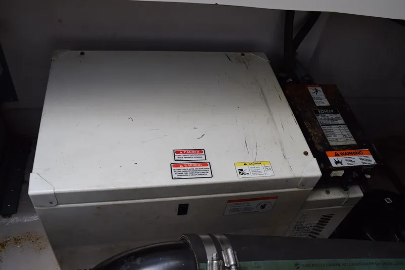 Slide: The Image of Engine compartment of a 2004 Sea Ray 390 Sundancer with warning labels visible. - 37