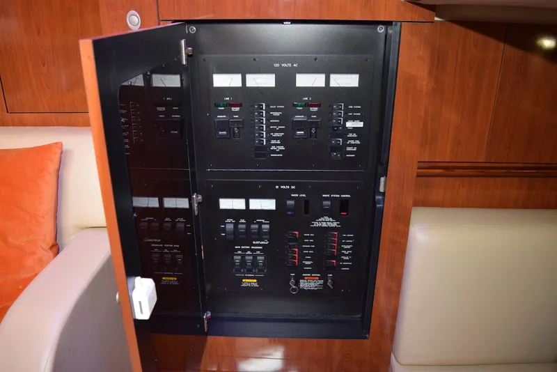Slide: The Image of Electrical panel inside a 2004 Sea Ray 390 Sundancer yacht, featuring various switches and controls. - 34