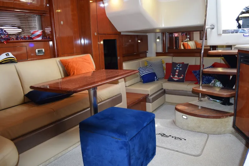 Slide: The Image of Luxurious interior of 2004 Sea Ray 390 Sundancer yacht with plush seating and elegant decor. - 26