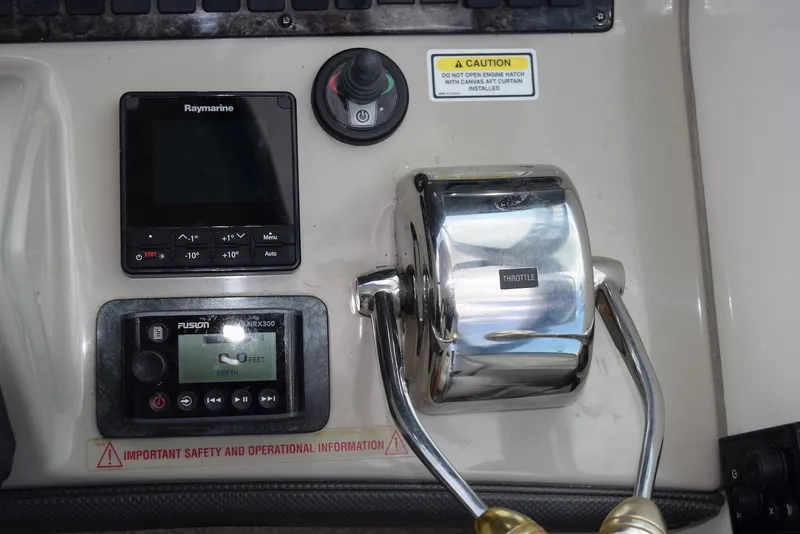 Slide: The Image of Control panel of a 2004 Sea Ray 390 Sundancer boat with throttle and navigation displays. - 21