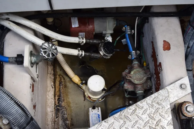 Slide: The Image of Engine compartment of a 2004 Sea Ray 390 Sundancer with visible plumbing and mechanical components. - 42