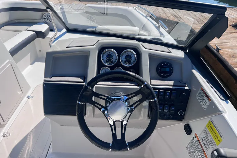 Slide: The Image of 2023 Starcraft SVX 210 IO boat dashboard with steering wheel and control panel. - 9