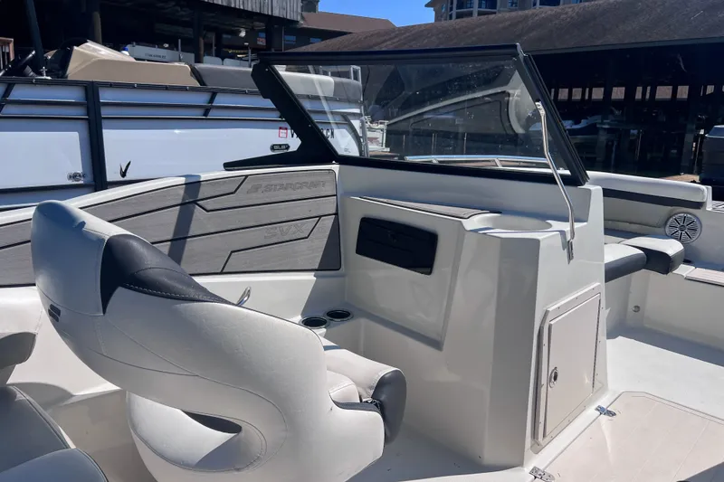 Slide: The Image of 2023 Starcraft SVX 210 IO boat interior with seating and dashboard. - 10