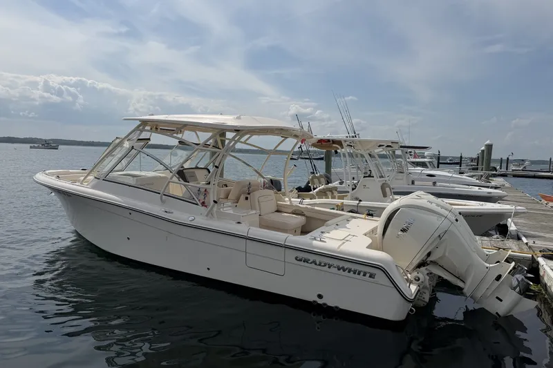 The Image of 2027 Grady-White Freedom 285 boat docked at marina under cloudy sky. - 0