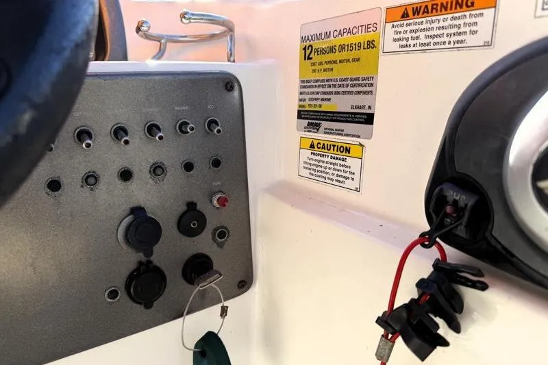 Slide: The Image of Control panel of 2022 Hurricane SunDeck Sport 201 OB boat with capacity warnings. - 27
