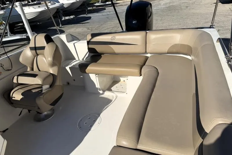 Slide: The Image of 2022 Hurricane SunDeck Sport 201 OB boat interior with beige seating and helm chair. - 22