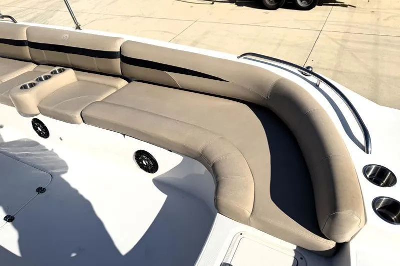 Slide: The Image of 2022 Hurricane SunDeck Sport 201 OB boat interior with beige seating and cup holders. - 18