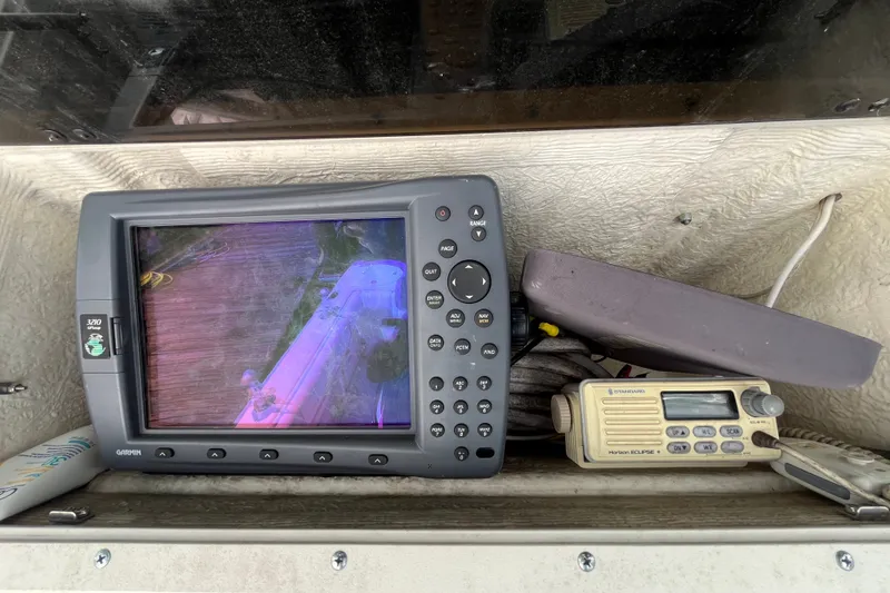 Slide: The Image of Garmin GPS and radio equipment on a 1999 Boston Whaler 230 Outrage boat. - 13