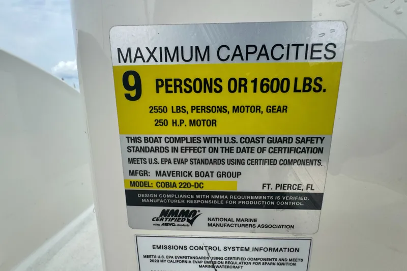 Slide: The Image of Capacity label for 2024 Cobia 220 Dual Console boat, max 9 persons or 1600 lbs. - 9