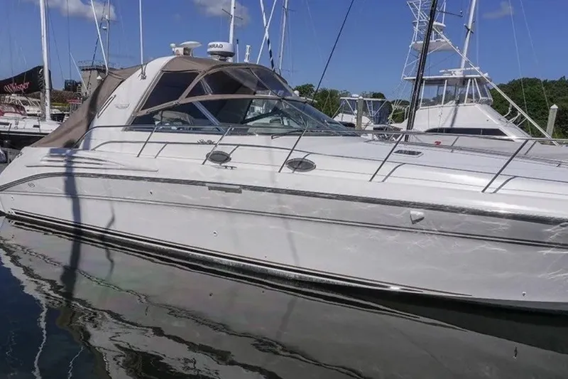 Slide: The Image of 1997 Sea Ray Sundancer 400 yacht docked in a marina under a clear blue sky. - 3