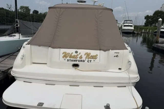 Slide: The Image of 1997 Sea Ray Sundancer 400 docked, covered, with "What's Next" nameplate, Stamford, CT. - 4