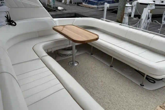 Slide: The Image of Luxurious seating area on a 1997 Sea Ray Sundancer 400 yacht with a wooden table. - 15