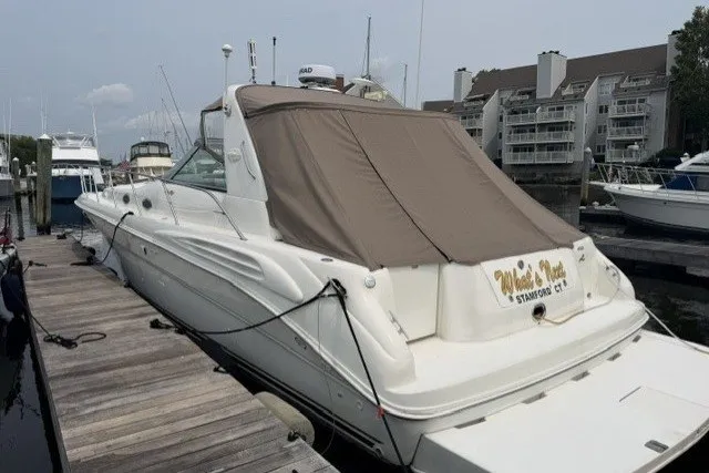 Slide: The Image of 1997 Sea Ray Sundancer 400 docked at marina with covered cockpit. - 5