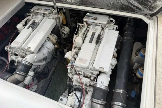 Slide: The Image of Engine compartment of a 1997 Sea Ray Sundancer 400, showcasing dual inboard engines. - 43