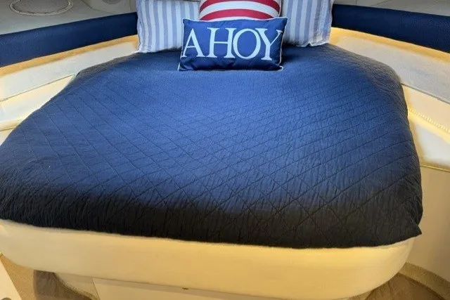 Slide: The Image of Cozy cabin interior of 1997 Sea Ray Sundancer 400 with nautical-themed bedding. - 24