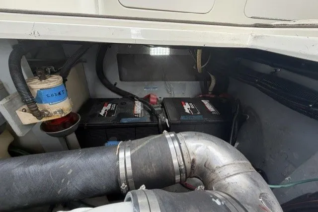 Slide: The Image of Engine compartment of a 1997 Sea Ray Sundancer 400 with visible batteries and wiring. - 41
