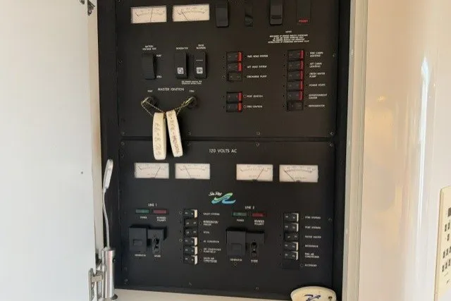 Slide: The Image of Electrical panel of a 1997 Sea Ray Sundancer 400 boat, featuring various switches and gauges. - 35