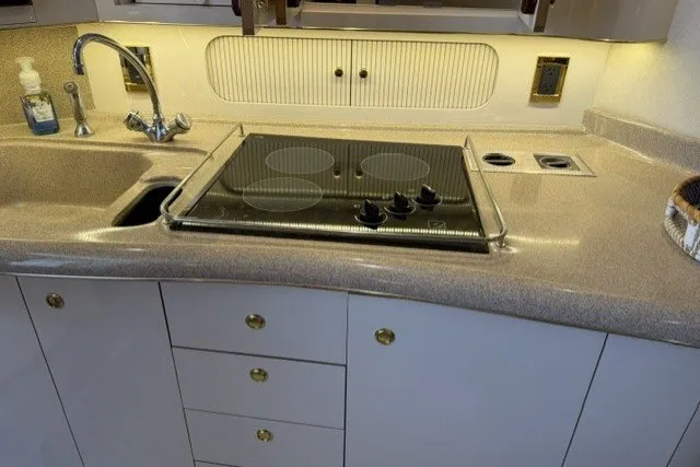 Slide: The Image of Kitchen area of a 1997 Sea Ray Sundancer 400 yacht with stove and sink. - 19