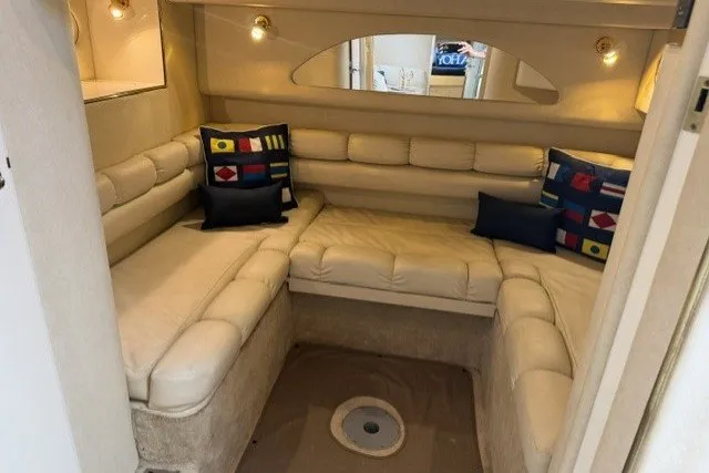 Slide: The Image of Interior of 1997 Sea Ray Sundancer 400 with plush seating and nautical-themed pillows. - 36