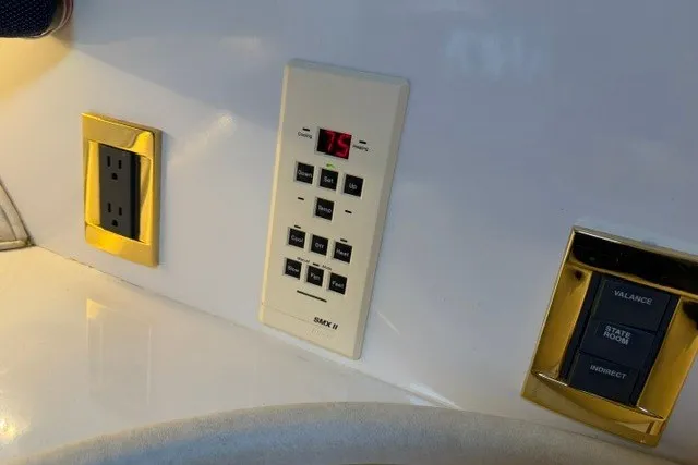 Slide: The Image of Control panel and outlets on a 1997 Sea Ray Sundancer 400 yacht interior. - 34