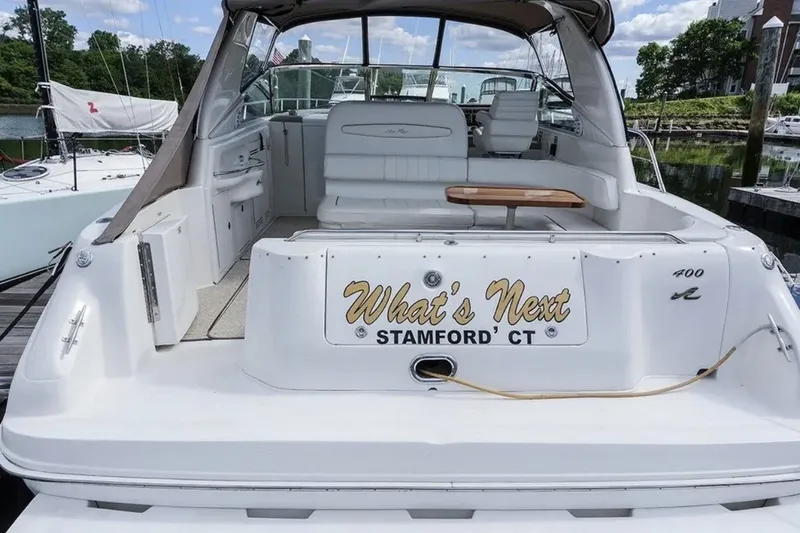 Slide: The Image of 1997 Sea Ray Sundancer 400 yacht docked, featuring spacious seating and "What's Next" nameplate. - 1