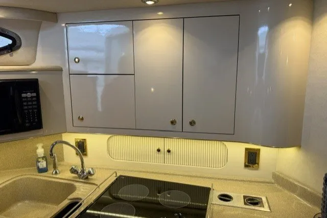 Slide: The Image of 1997 Sea Ray Sundancer 400 yacht kitchen with modern cabinetry and appliances. - 18
