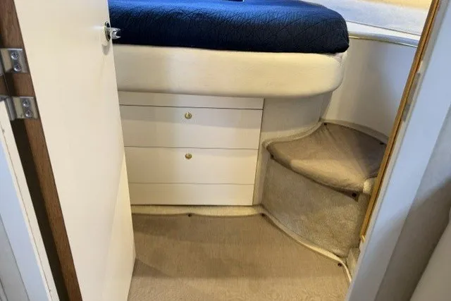 Slide: The Image of Interior cabin of 1997 Sea Ray Sundancer 400 with bed and storage drawers. - 22