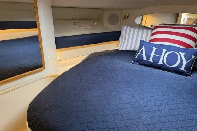 Slide: The Image of Cozy cabin interior of 1997 Sea Ray Sundancer 400 with nautical-themed pillows. - 26