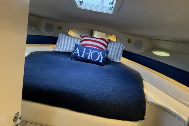 Slide: The Image of Cozy cabin interior of 1997 Sea Ray Sundancer 400 with nautical-themed bedding. - 21