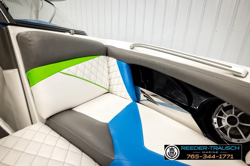 Slide: The Image of 2013 Tigé RZR boat interior with colorful upholstery and speaker detail. - 40