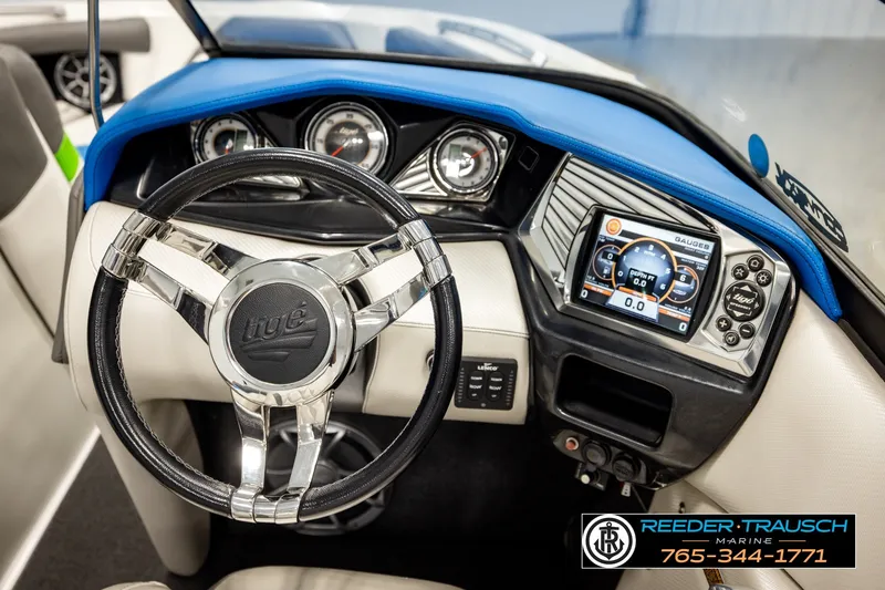 Slide: The Image of 2013 Tigé RZR boat dashboard with steering wheel and digital display. - 29