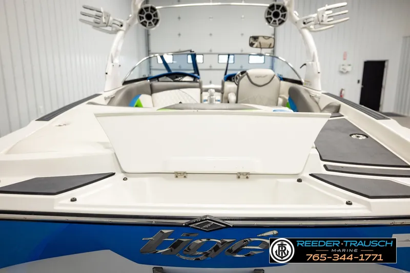Slide: The Image of 2013 Tigé RZR boat interior, showcasing sleek design and modern features in a showroom setting. - 48