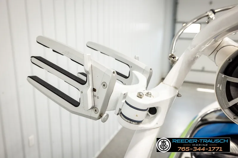 Slide: The Image of 2013 Tigé RZR wakeboard rack in a showroom, featuring sleek white design. - 46