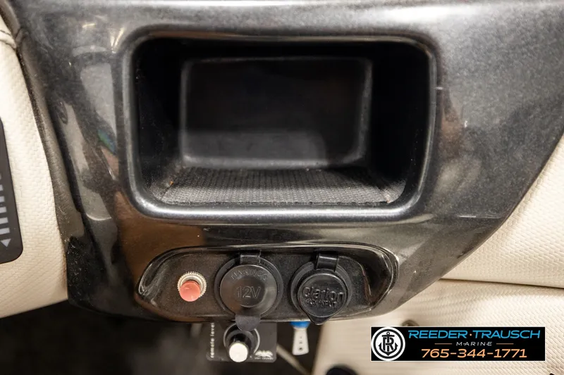 Slide: The Image of 2013 Tigé RZR dashboard with 12V socket and storage compartment. - 35