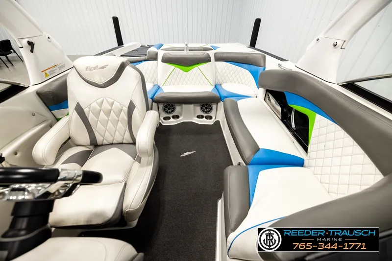 Slide: The Image of 2013 Tigé RZR boat interior with white, blue, and green seating. - 16