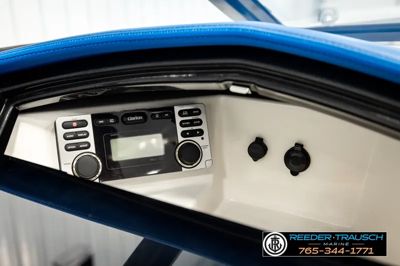 Slide: The Image of 2013 Tigé RZR boat dashboard featuring a Clarion audio system and control panel. - 37