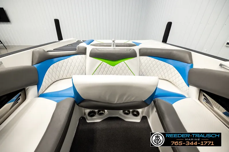 Slide: The Image of Interior of 2013 Tigé RZR boat with blue, green, and white seating. - 18