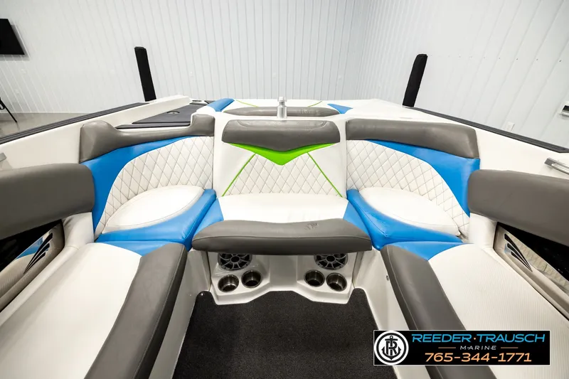 Slide: The Image of Interior of 2013 Tigé RZR boat with blue, white, and green seating. - 17