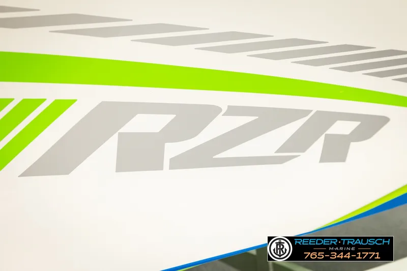 Slide: The Image of 2013 Tigé RZR boat with bold graphics and Reeder Trausch Marine contact details. - 55
