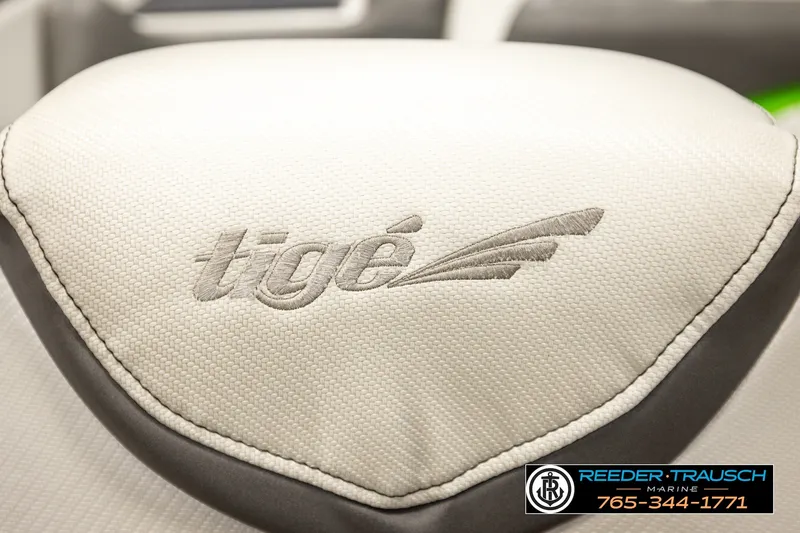 Slide: The Image of 2013 Tigé RZR boat seat with embroidered logo, featuring Reeder-Trausch Marine contact details. - 39