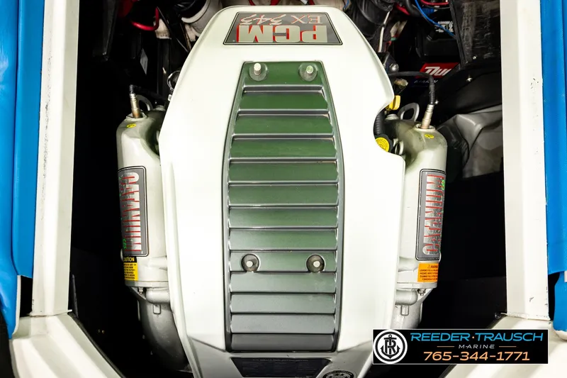 Slide: The Image of Engine compartment of a 2013 Tigé RZR boat, featuring a PCM EX343 engine. - 21